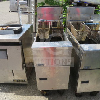 Pitco SG14 natural gas deep fryer with 2 baskets, on casters. Measures 15.5x34x45.5 inches. Visible wear on the exterior.