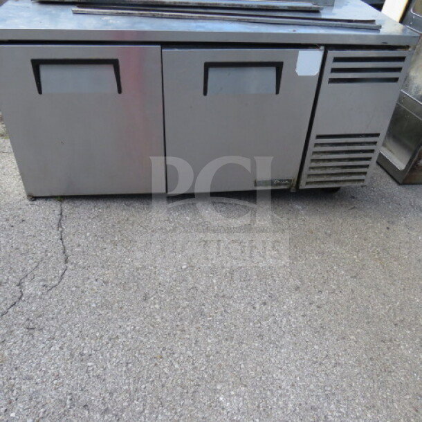 True 2 Door Freezer, model TWT-67F-HC, with 3 racks and casters. Measures 67x32x39 inches. 115 Volt. Used condition.
