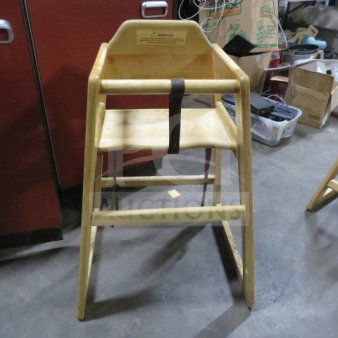 Wooden high chair with safety straps, natural finish, sturdy build, visible warning label, used condition.