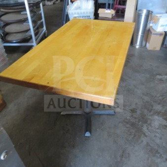 Solid wooden table top on a pedestal base, measures 48x30x30 inches. Shows signs of wear, natural wood finish.