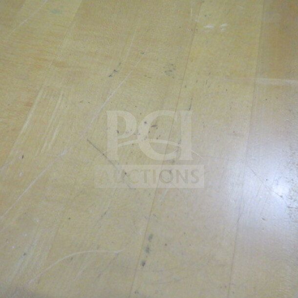 Solid wooden table top with pedestal base, 42x30x30 inches, shows signs of wear with visible surface scratches.