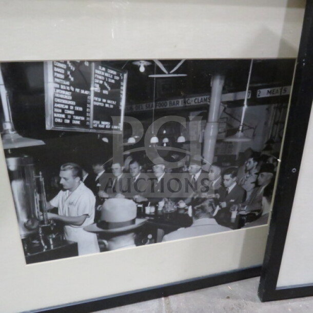 17X21.5 framed vintage-style photo of a crowded diner scene, black and white. Black frame, glass cover.