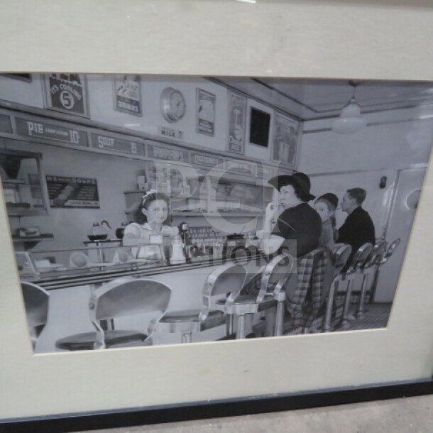 Vintage-style framed black-and-white diner photo, 17x21.5 inches, featuring counter service scene. Good condition.