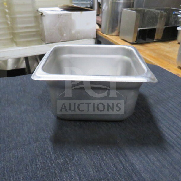1/6 size hotel pan, 4-inch deep. Stainless steel, used condition. Ideal for commercial kitchen use. Model 5XBID.