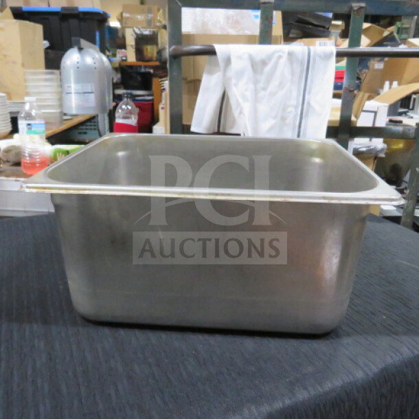 1/2 size stainless steel hotel pan, 6-inch deep, in good condition, suitable for commercial kitchen use.