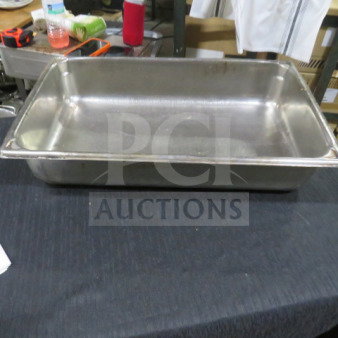Stainless steel full-size hotel pan, 4-inch deep, used condition, ideal for food service, no visible markings.