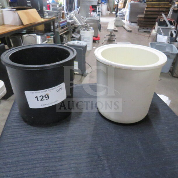Two assorted refrigerated bowls, black and white, in good condition. Black bowl labeled with lot number 129.