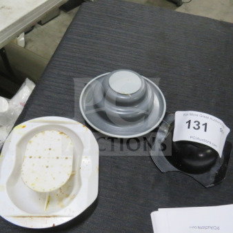 Assorted meat tenderizers displayed on a table, including white and gray plastic models with label number "131".