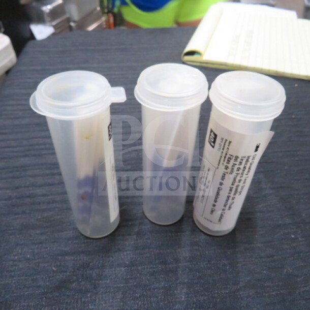 A lot of three test strip containers with secure lids, visible labels, and manufacturer details. Appears in good condition.