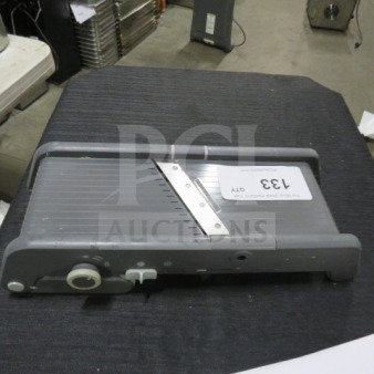 Gray heavy-duty mandolin slicer with adjustable settings, model number 133, used condition, on black surface.