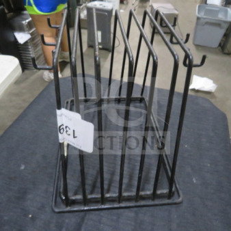 Black metal one pan rack with multiple slots, in good condition. Auction tag labeled "139" attached to the side.