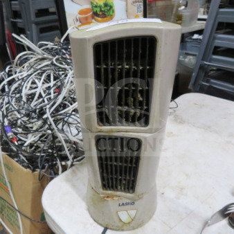 Lasko fan with dual vents, ivory color, evident wear and dust. Lasko logo at base. Suitable for parts or restoration.