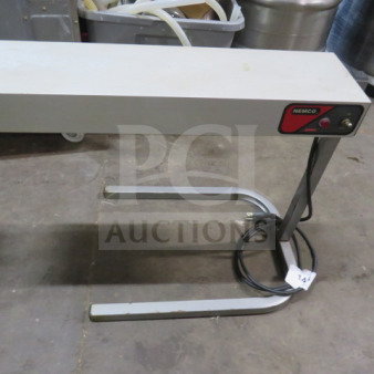 Nemco 6152-24 warmer in good condition, 120V. Features include a metal frame and power cord, ideal for commercial use.