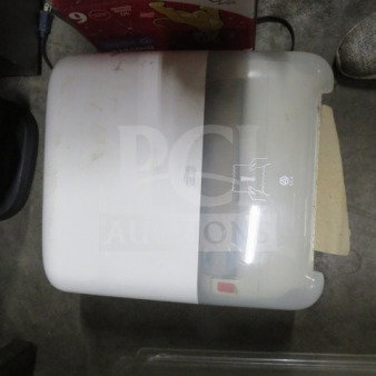 Tork paper towel dispenser, model 2XBID, white, visible scuff marks, wall-mounted with semi-transparent front cover.