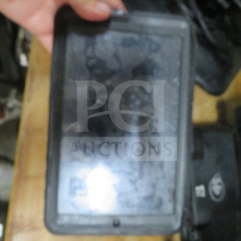 A tablet in a rugged black case, screen slightly smudged, no cords included. Condition appears to be used.