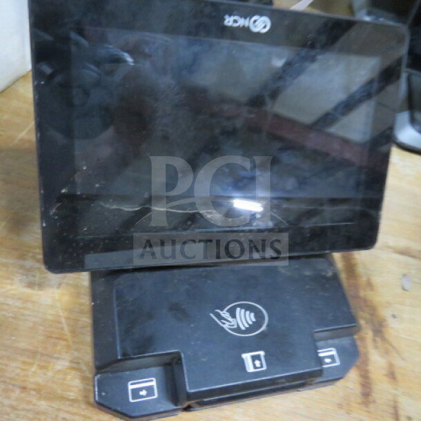 NCR POS Terminal with touchscreen, used condition. Missing cords. Features contactless payment symbol on base.