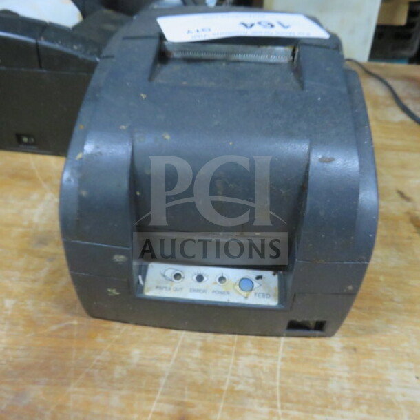 Bixolon thermal printer, pre-owned, with visible wear, control panel showing power and feed buttons. Model unspecified.