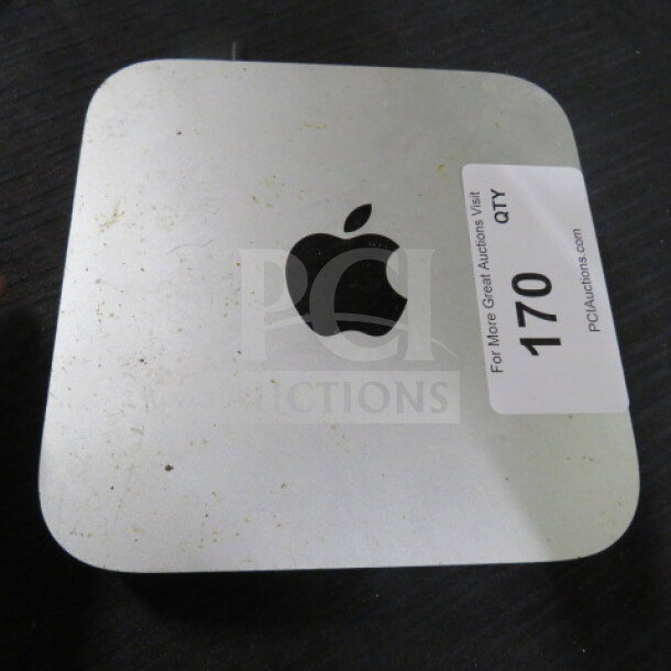 Apple Mac Mini with visible signs of wear. Auction tag "170 QTY" indicating lot number.