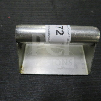Stainless steel steak weight with handle, used condition, auction tag visible.