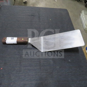 XXL hamburger turner with stainless steel blade, wooden handle, and numbered tag. Good condition.