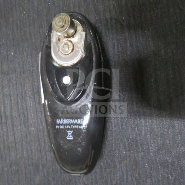 Farberware can opener, black, 8V DC, Type A116. Shows signs of use; visible blade and handle details.