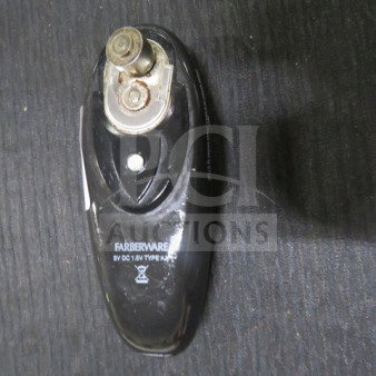 Farberware can opener, black, 8V DC, Type A116. Shows signs of use; visible blade and handle details.