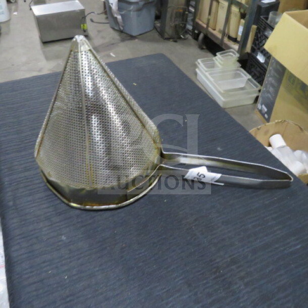 Stainless steel cone strainer with perforated holes, attached handle. Label displays "45." Used, good condition.