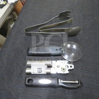 Assorted kitchen utensils including tongs, can opener, pizza cutter, and peeler on black surface, labeled "89".
