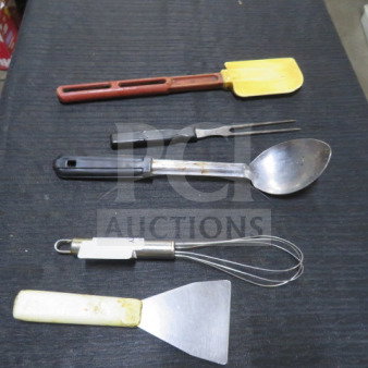 Assorted kitchen utensils including a spatula, fork, spoon, whisk, and scraper on a black surface. Various conditions.
