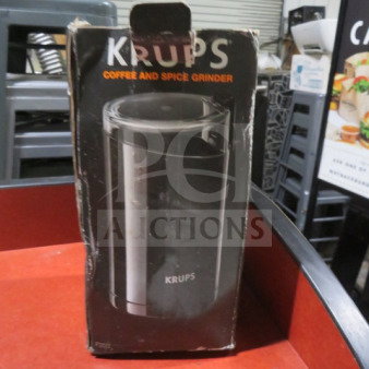 Krups Coffee Grinder in worn packaging, black model pictured on box, used for grinding coffee and spices.
