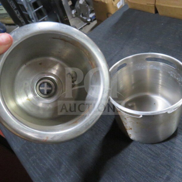 Stainless steel dipperwell, two parts, minor wear, visible markings inside, essential for maintaining hygiene in beverage stations.