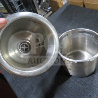 Stainless steel dipperwell, two parts, minor wear, visible markings inside, essential for maintaining hygiene in beverage stations.