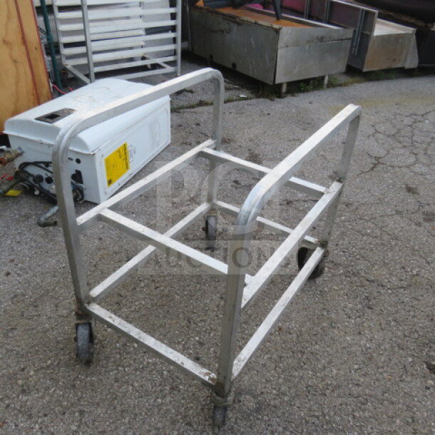 Aluminum cart on casters, 18.5x26x27 inches, used condition. Sturdy metal frame, ideal for transporting items.