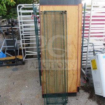 Green Metro shelf, 60x14 inches, wire construction. Used condition, located outdoors amidst other metal equipment.