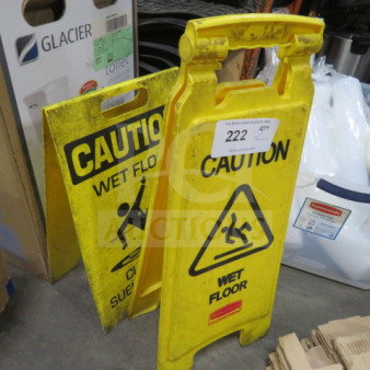 Assorted yellow caution wet floor signs, two pieces, featuring bold text and slipping figure icon, fair condition.
