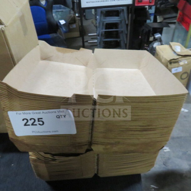 Stack of flat, brown paper boxes with label "225 QTY." Boxes appear unused and neatly stacked.