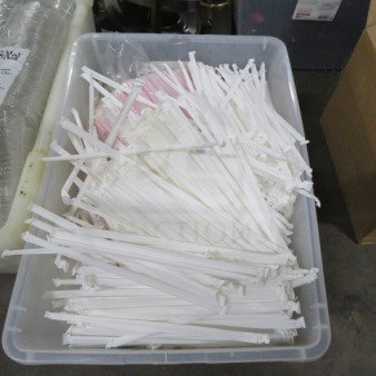Box of assorted to-go paper products, including white straws and lids, in good condition for catering or restaurant use.