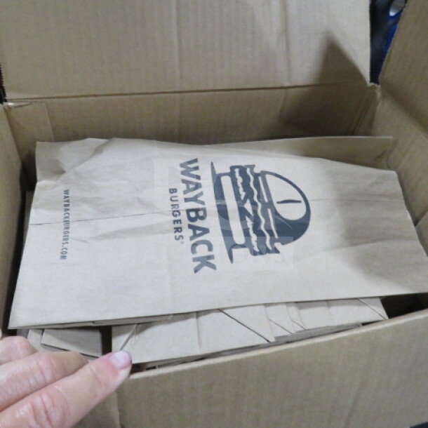 Box of Wayback Burgers paper bags, featuring the logo and website. Bags appear new and neatly stacked.