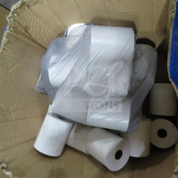 Lot of roll printer tape, multiple rolls in cardboard box, varying sizes, white with black cores, wrapped in plastic.
