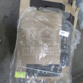 A lot of catering boxes wrapped in plastic. Boxes are stacked, with a label numbered "237". Some labels on packaging.
