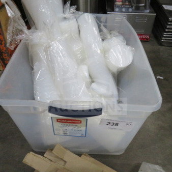 A box of assorted plastic lids, bagged and assorted, in a clear Rubbermaid container. Visible label with lot number 238.