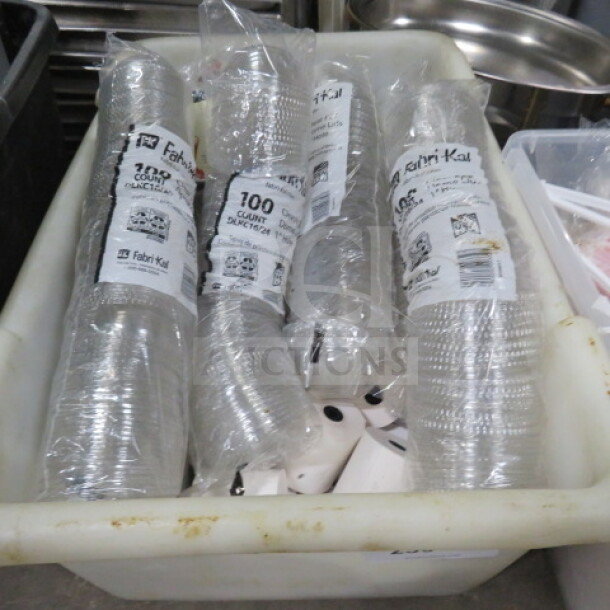 A bin containing assorted cup lids, including packs labeled Fabri-Kal, 100 count, clear plastic.