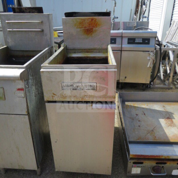 One American Range natural gas deep fryer, 15.5x30x46 inches, with visible wear and rust, branded front panel.