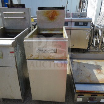 One American Range natural gas deep fryer, 15.5x30x46 inches, with visible wear and rust, branded front panel.