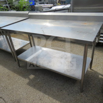 Stainless steel table with SS under shelf and backsplash, measuring 60x30x40. Good condition, ideal for kitchen use.