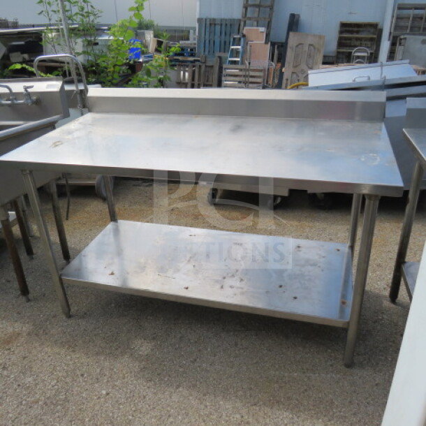Stainless steel table with under shelf and backsplash, 60"x30"x40", used condition.
