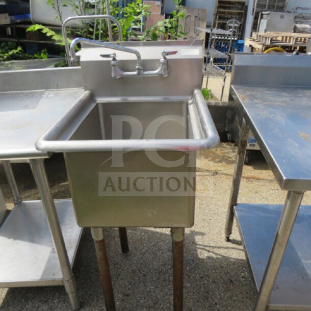 Stainless steel stand-alone sink with dual-handle faucet, dimensions 21x26x44 inches, in good condition.