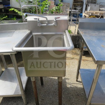 Stainless steel stand-alone sink with dual-handle faucet, dimensions 21x26x44 inches, in good condition.
