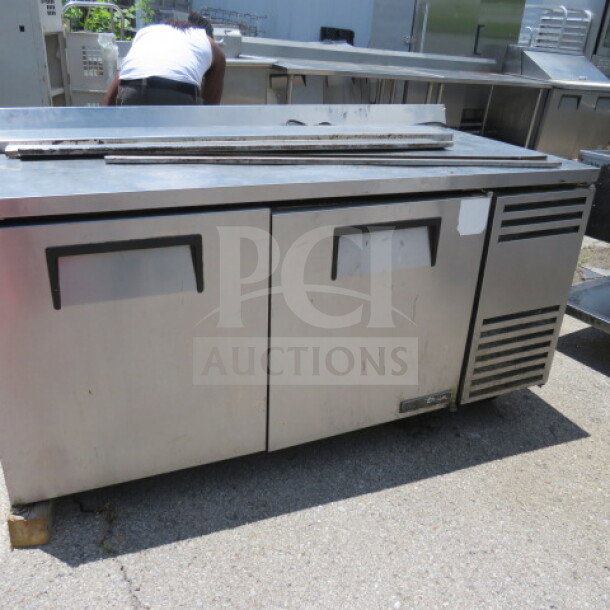Atosa 2 Door Freezer, Model MGF8406, with 2 racks on casters. Dimensions 48x30x37. Stainless steel, good condition.