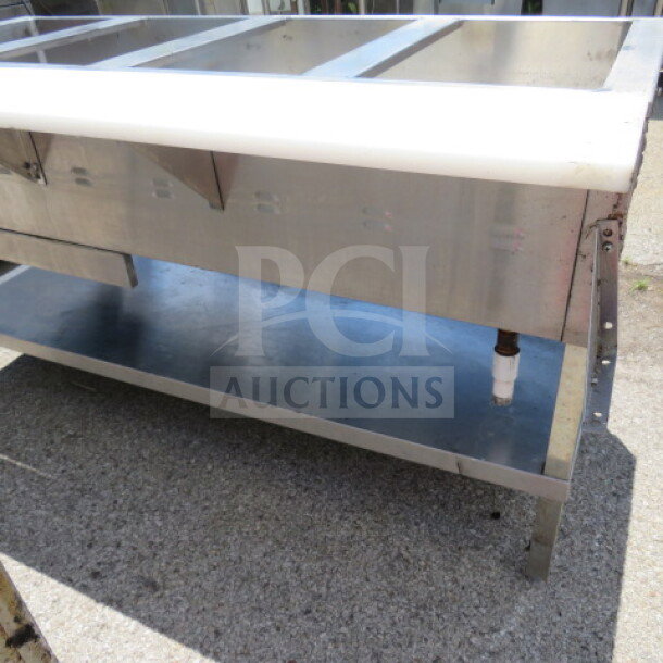 Eagle 4-well steam table, 63x32.5x34.5, with stainless steel undershelf and cutting board, used condition.